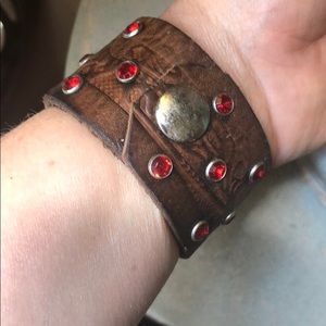 Brown leather cuff with red crystals
